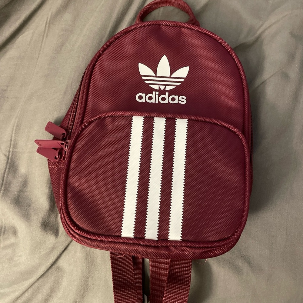 Adidas mini backpack. In color burgundy. Mint condition. Only used once.